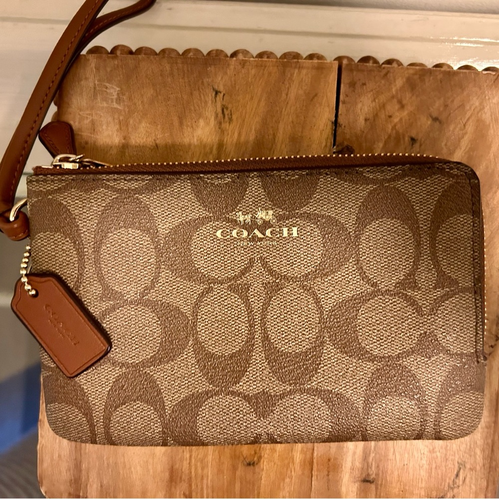 Coach Wristlet in Signature Canvas.